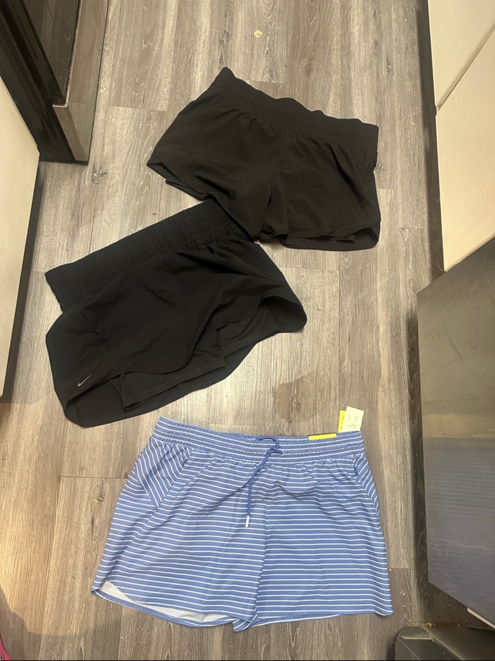 One pair of women’s Nike skirt with shorts under and other two are shorts